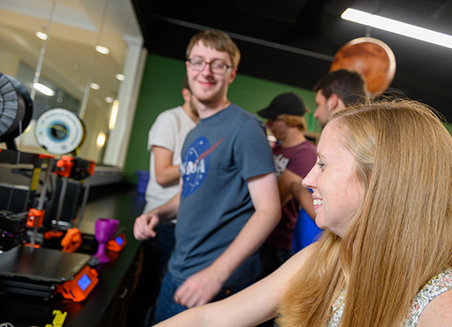 Dr. Briana Fiser with physics students
