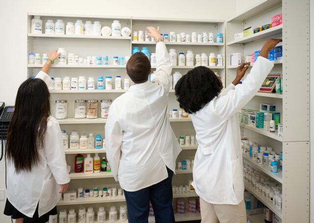 PharmD students organizing medications during a hands-on lab at the Fred Wilson School of Pharmacy at HPU