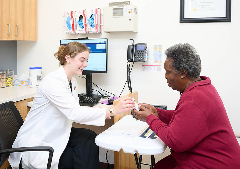PharmD student consulting with a patient during a clinical rotation at the Fred Wilson School of Pharmacy at HPU