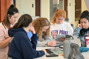 High Point University Doctor of Physical Therapy students studying in lobby of Congdon School of Health Sciences.