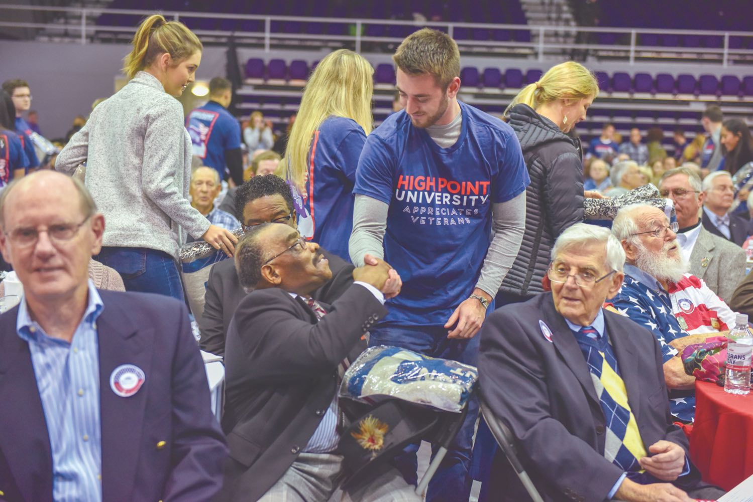 Veterans Day Celebration Student shakes hand with veteran